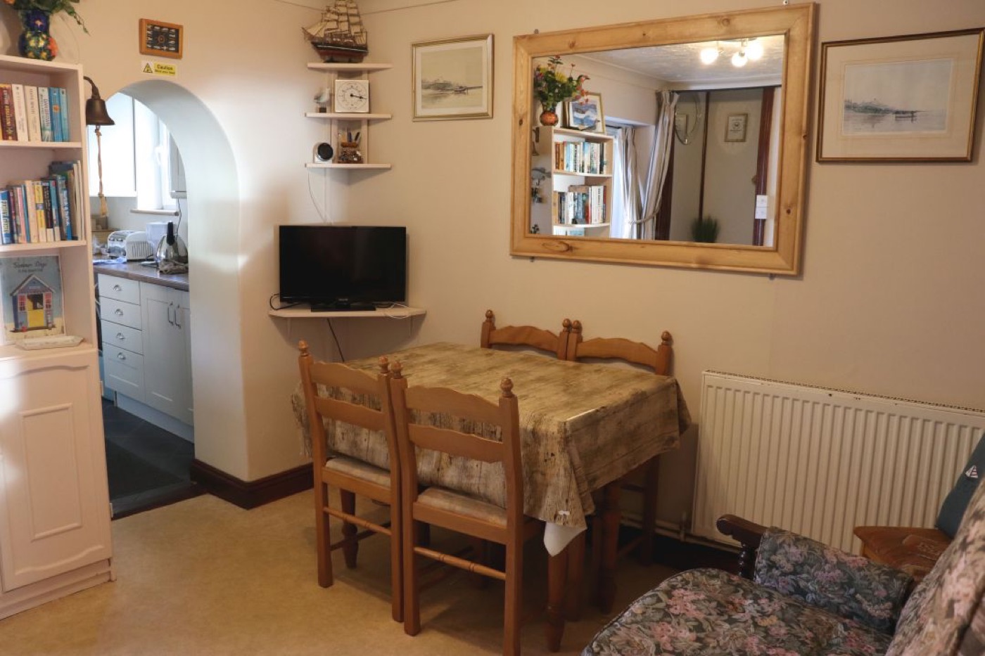 The dining room at Splashpoint, with table, chairs and bookcase